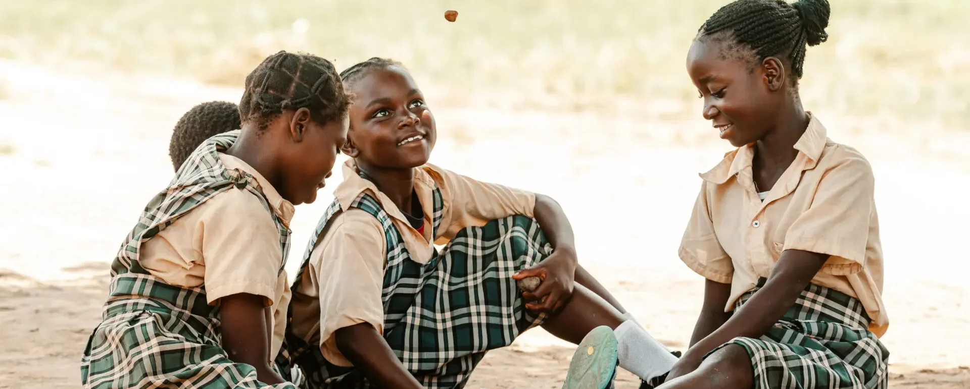Schoolgirls in uniform sitting together and laughing