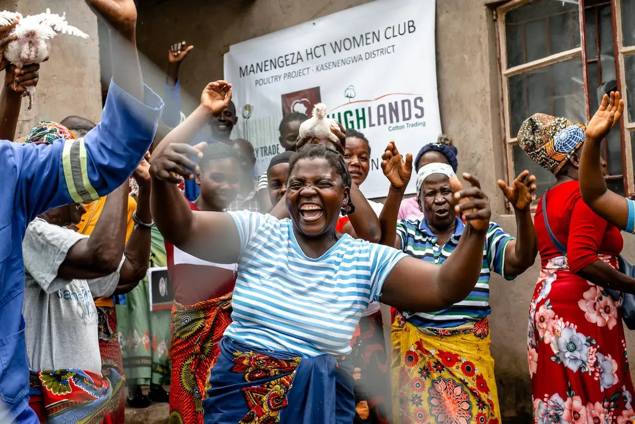 Members of the Manengeza women’s club celebrating under their banner