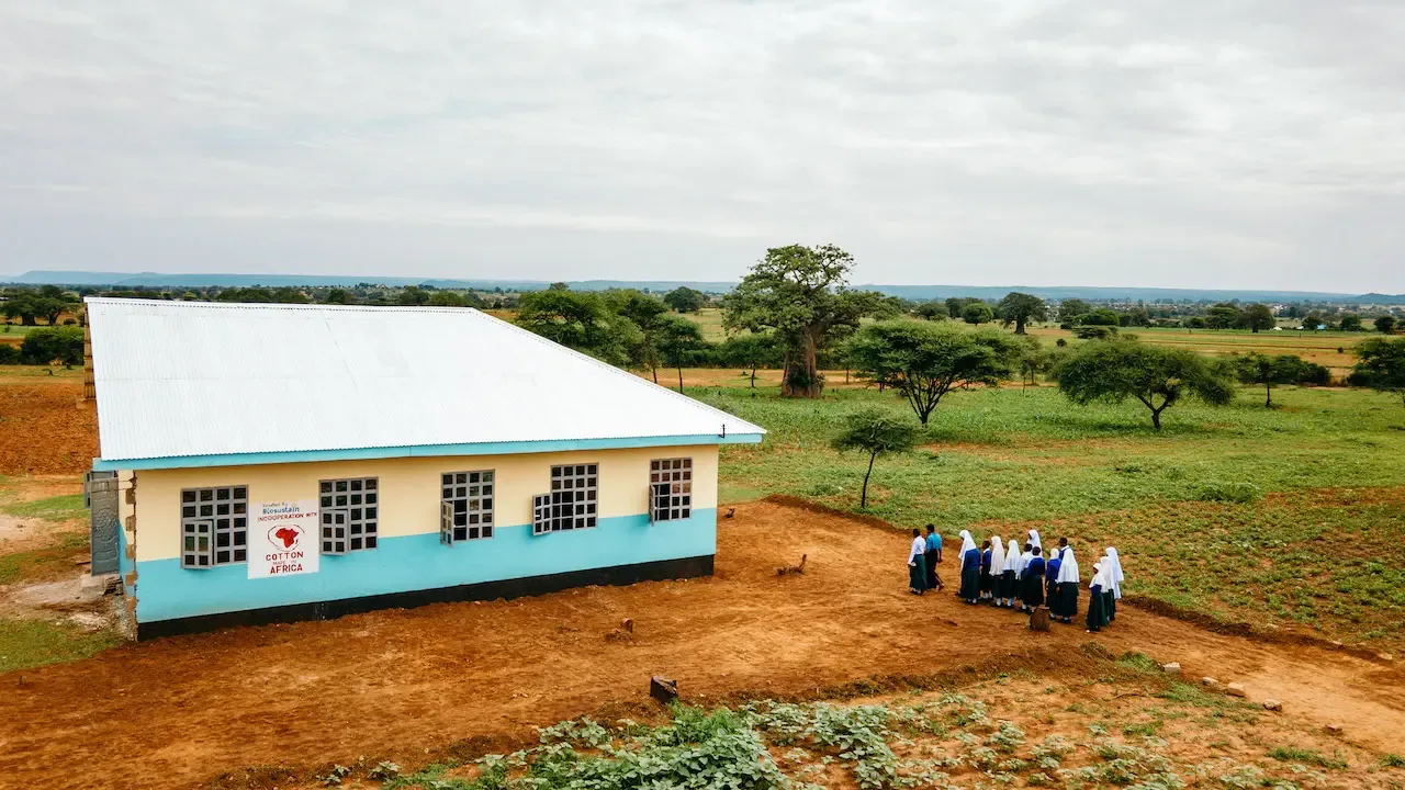 A school building with pupils in the yard