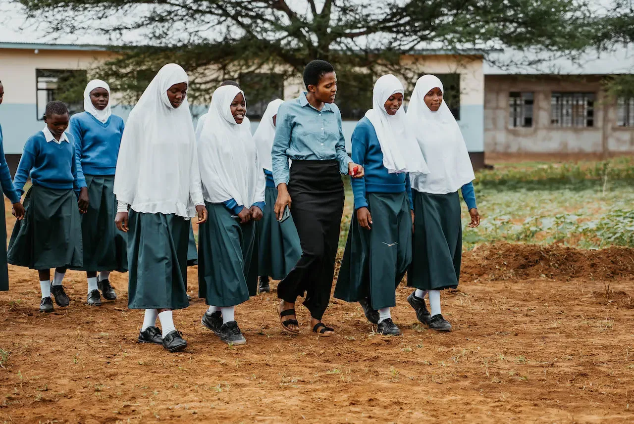Schoolgirls in white headscarves walking to class