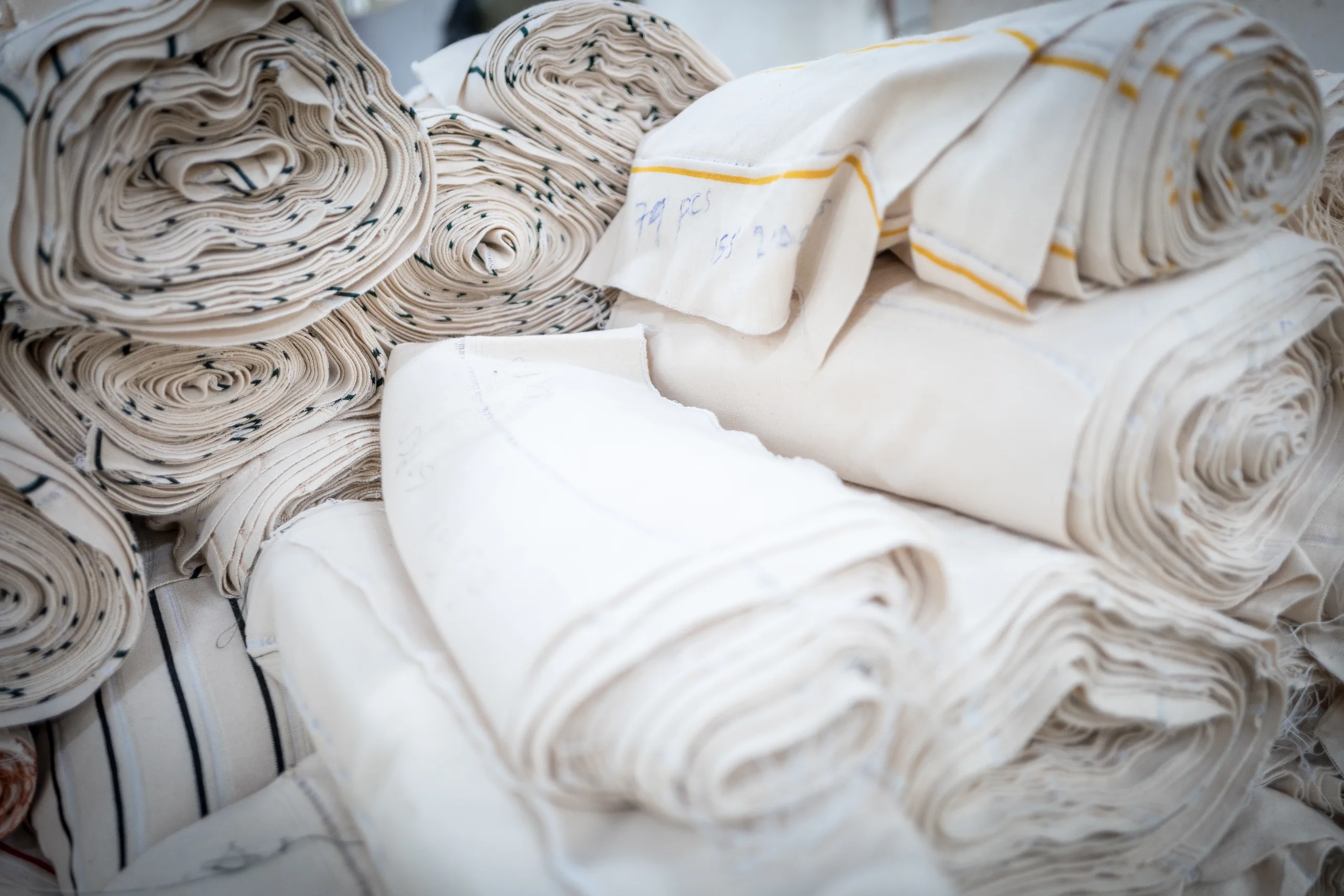 Folded white fabric stacked in a mill