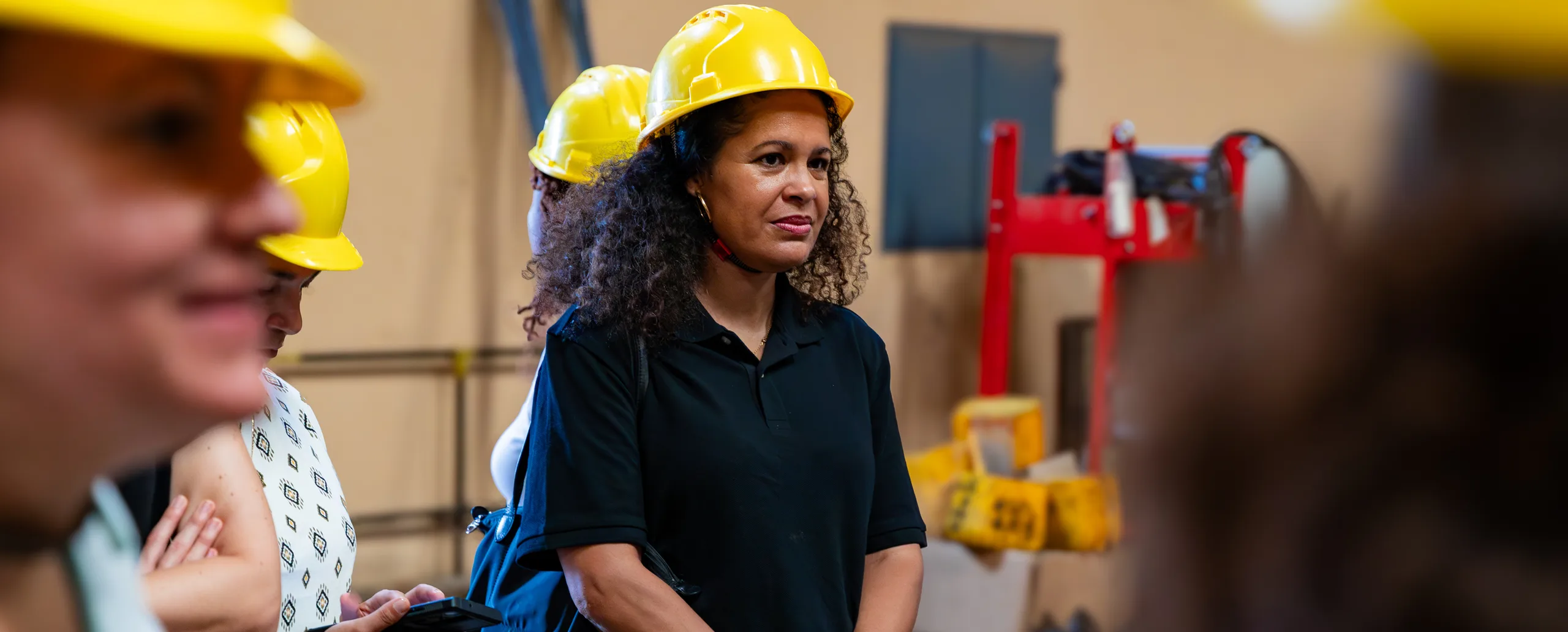 A woman in a hard hat on the factory floor