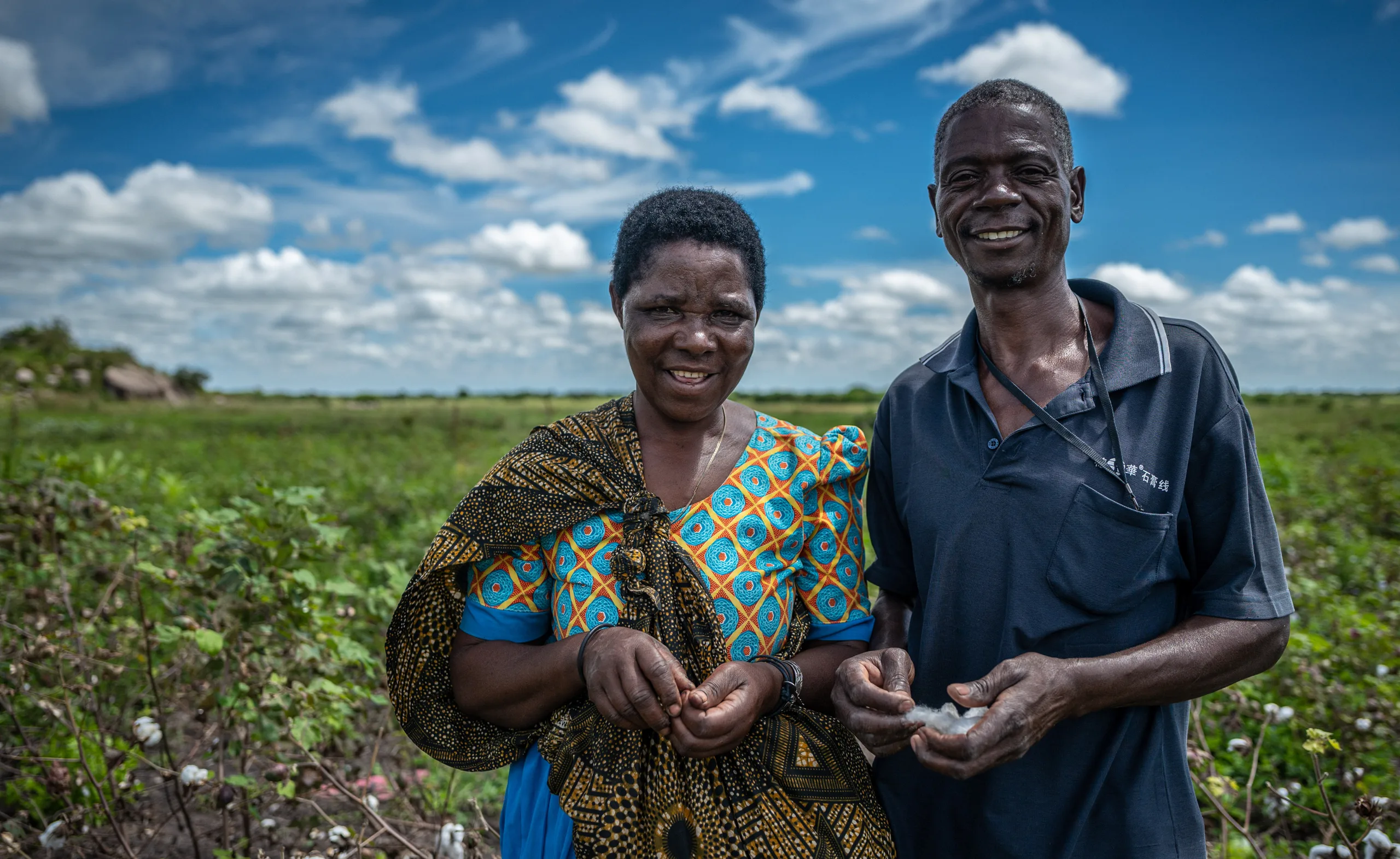 A couple standing in their cotton field