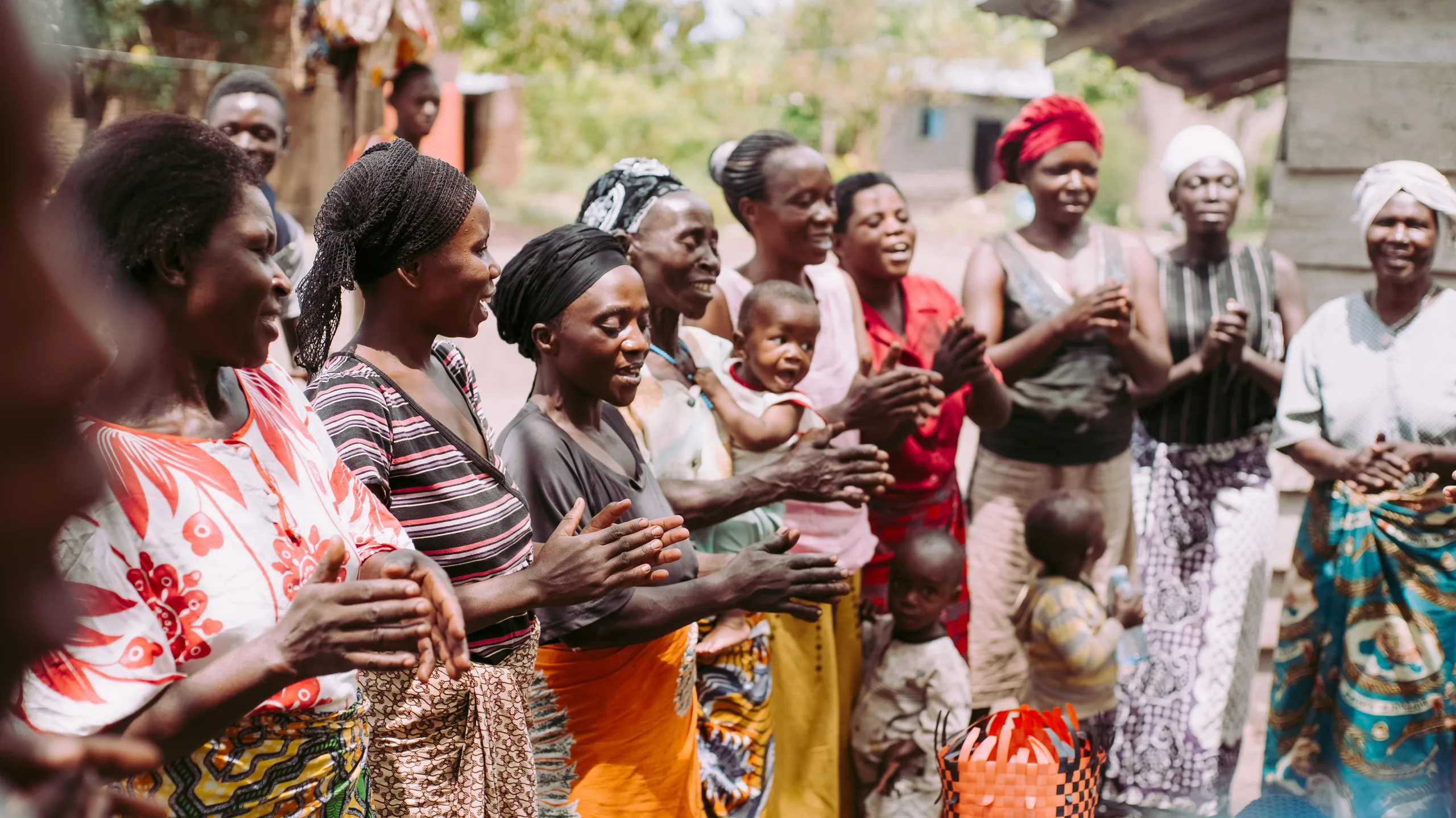 Women and children clapping together
